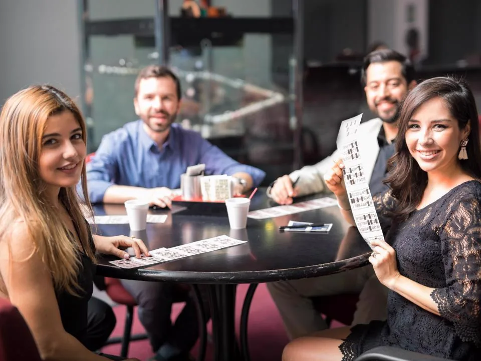 Group of people playing bingo together at a table