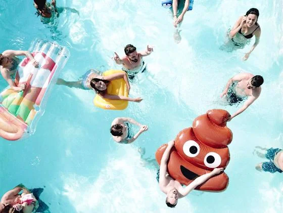 Residents enjoying a fun pool party with colorful floats