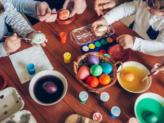 Children decorating colorful Easter eggs during a creative workshop
