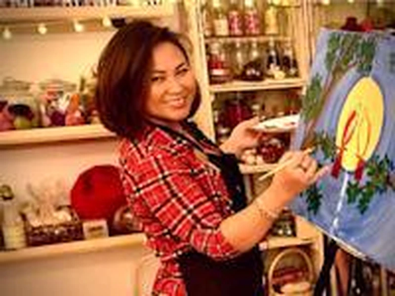 Portrait of Lia Morrison leading a Wine & Paint (BYOB) workshop for apartment community resident events.
