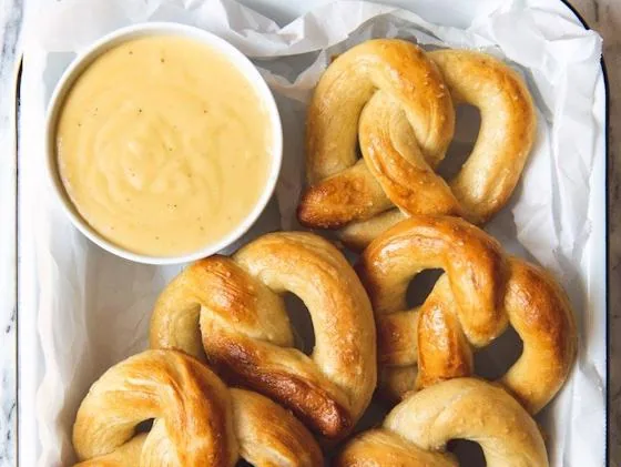 Freshly baked soft pretzels served with creamy cheese dip