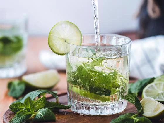 Fresh mojito being prepared with mint and lime