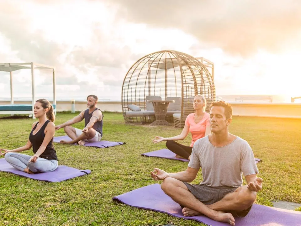 Outdoor yoga and wellness session on a grassy rooftop