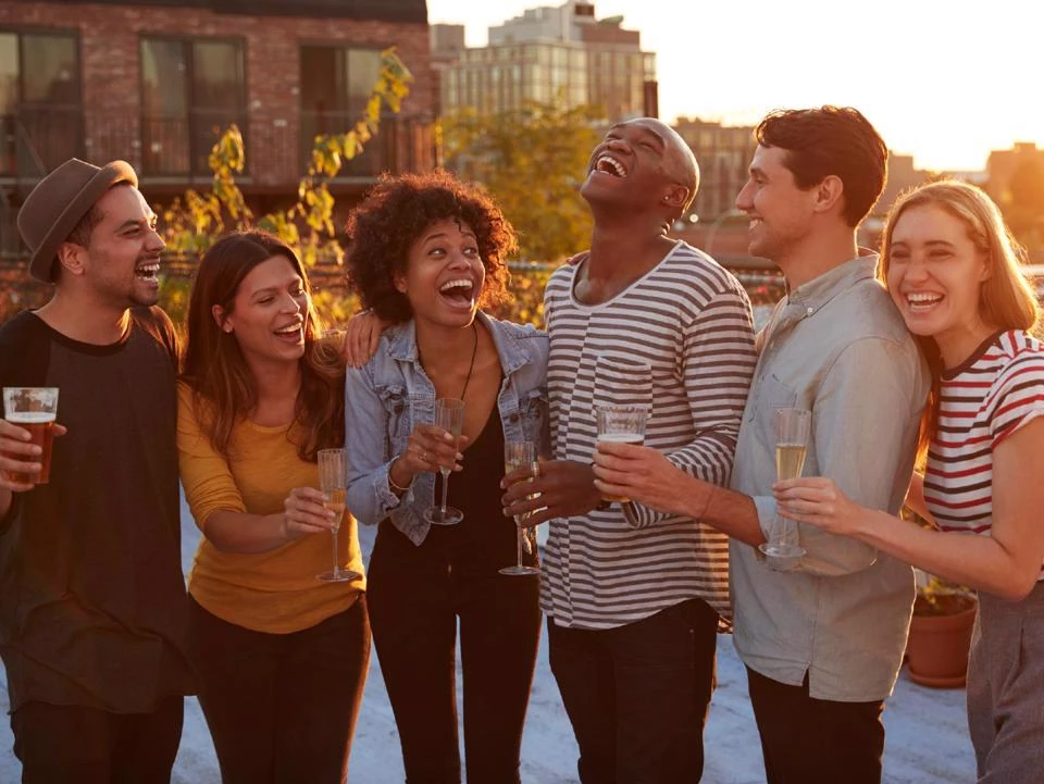 Residents enjoying wine and conversation at an outdoor community social event
