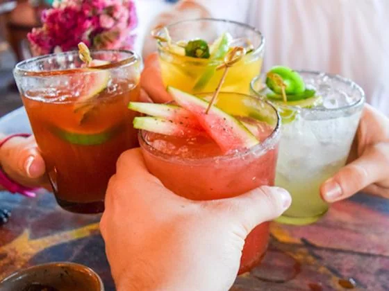Colorful fresh cocktails shared during a spring poolside celebration