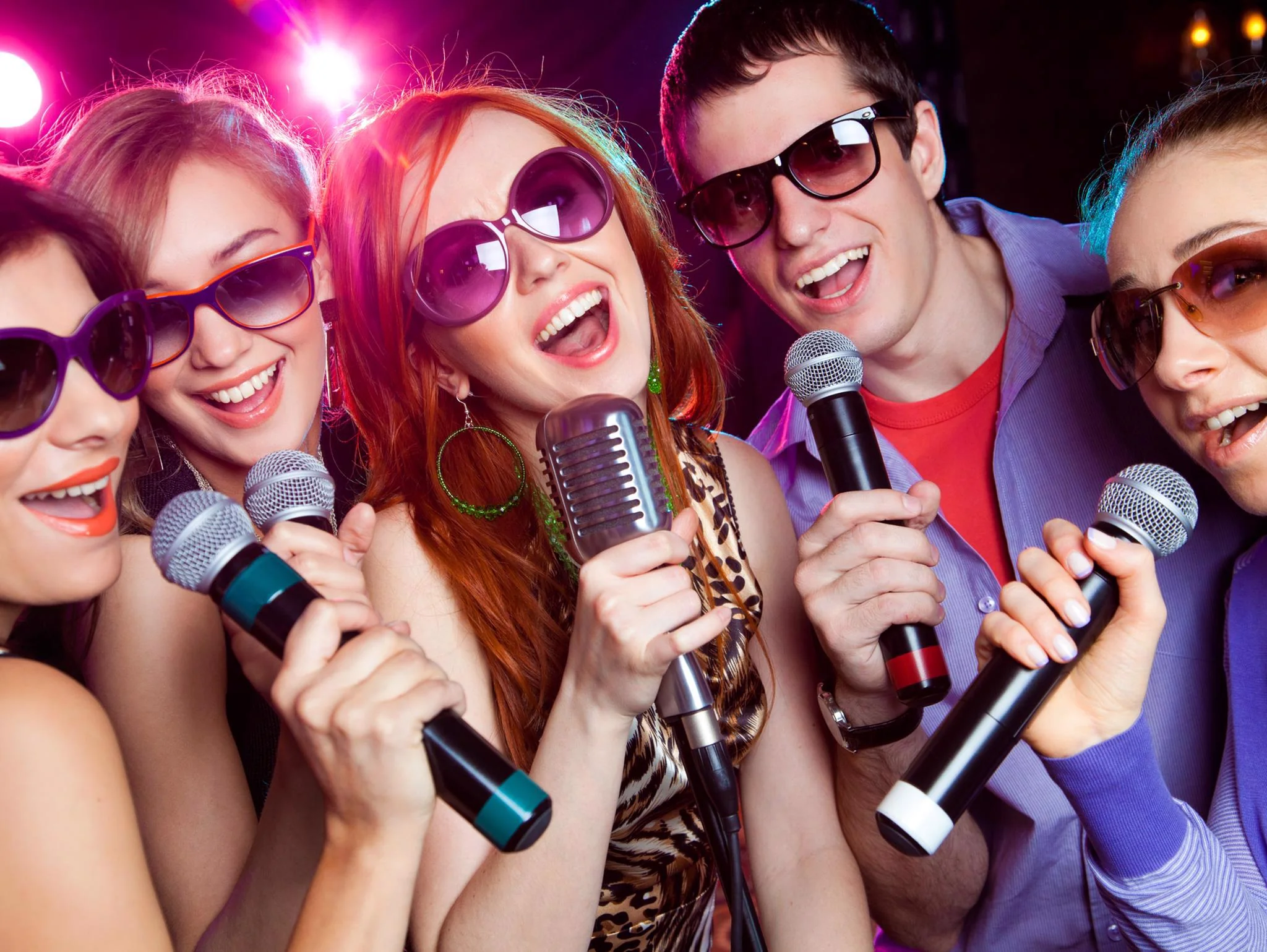 Friends singing karaoke together at a 4th of July party
