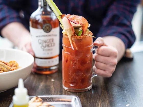Spicy Bloody Mary cocktail with festive garnish at a Día de Muertos event