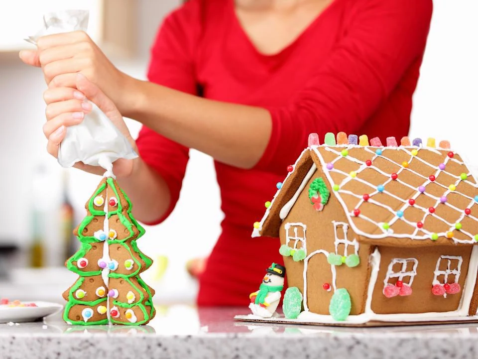 Resident decorating a gingerbread Christmas tree cookie with icing