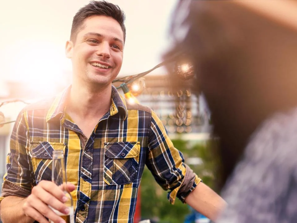 Guests enjoying drinks at a golden hour resident event