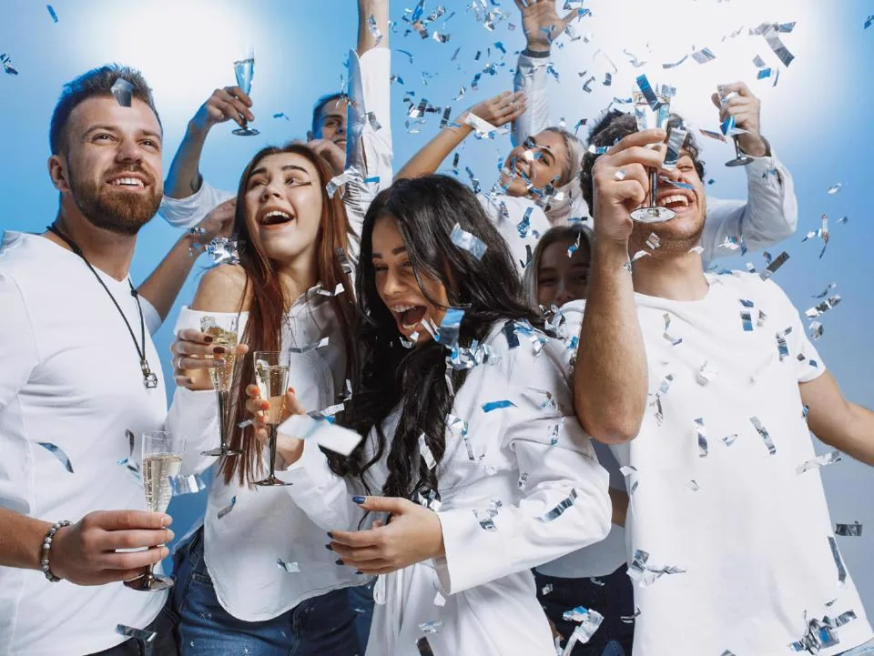 Residents celebrating together with drinks and confetti at The Grand Gathering