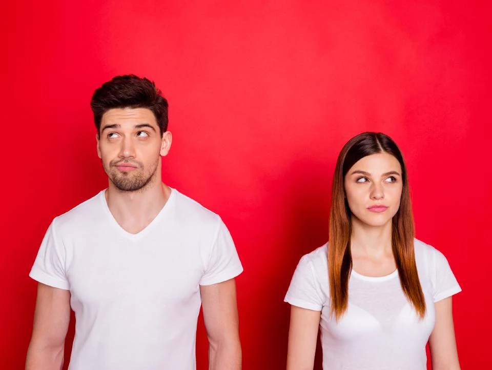 Couple wearing Santa hats and posing for a festive holiday trivia event