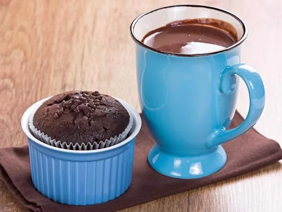Hot cocoa and chocolate muffin served at a festive holiday gathering
