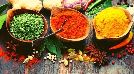 Colorful Indian spices including turmeric, chili and dried herbs