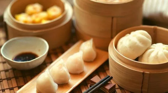 Assorted international dumplings served in bamboo steamers