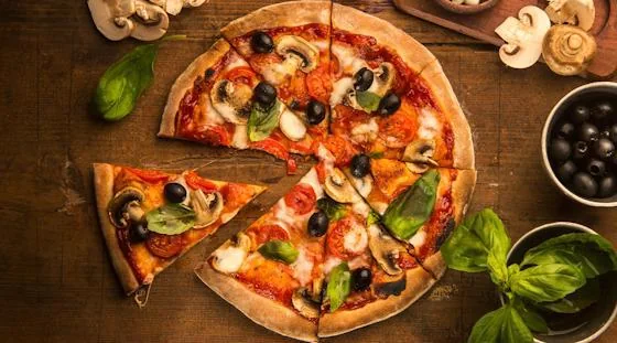 Homemade Italian pizza with mushrooms, olives, tomatoes and basil