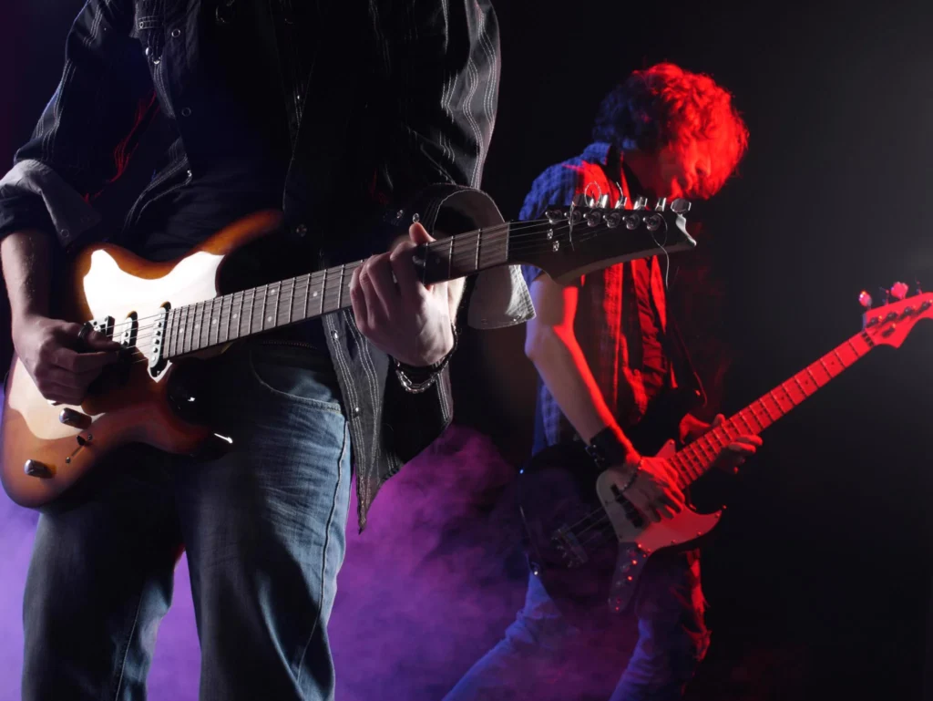 Live band performing with guitars at a 4th of July event