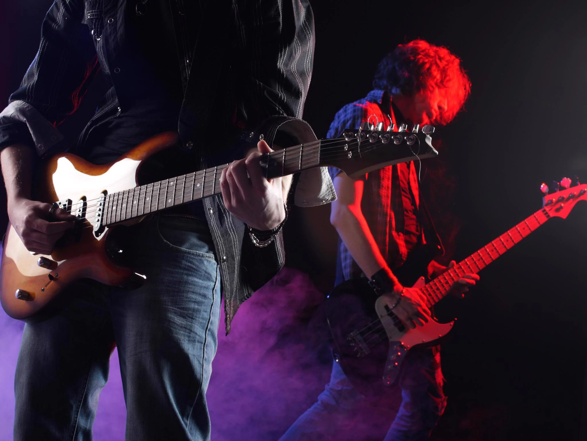 Live band performing with guitars at a 4th of July event