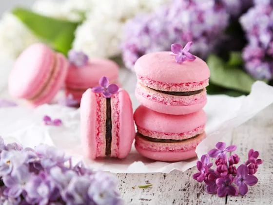Pink French macarons with delicate flowers for a resident cooking class