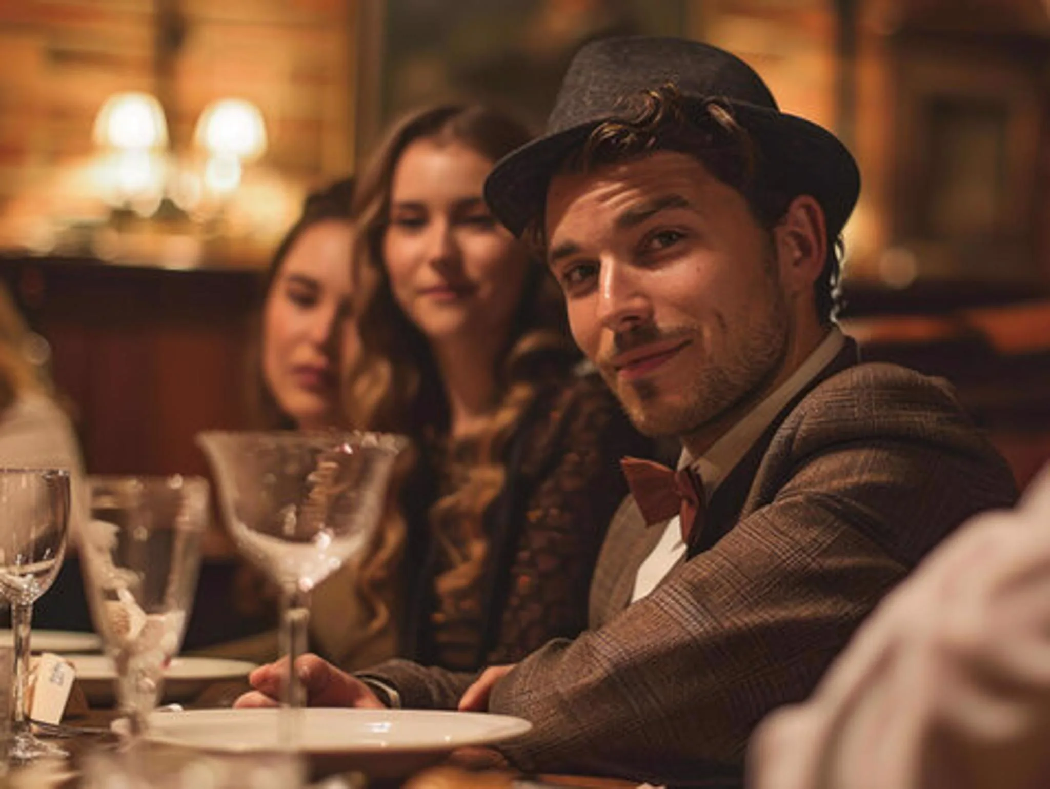 Guest in vintage attire enjoying a murder mystery dinner party
