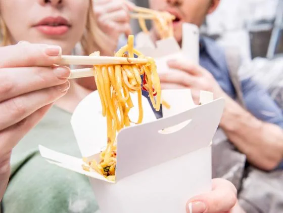 Residents enjoying noodle bar food at an apartment community event