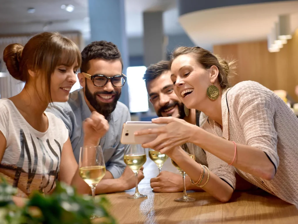 Residents socializing and using a smartphone at an app launch party