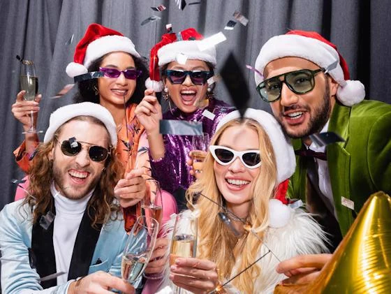 Friends wearing Santa hats and celebrating at a festive holiday party