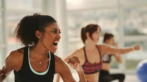 Residents participating in an instructor-led self-defense class