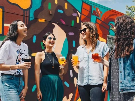 Friends enjoying drinks and conversation at an outdoor singles social