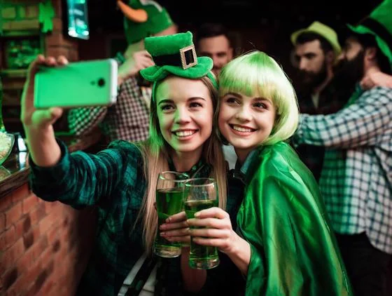 Friends celebrating St. Patrick’s Day with green drinks at a festive party