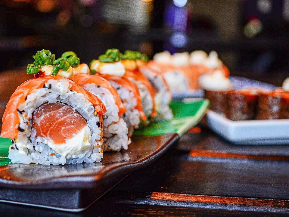Fresh salmon sushi rolls served on a platter
