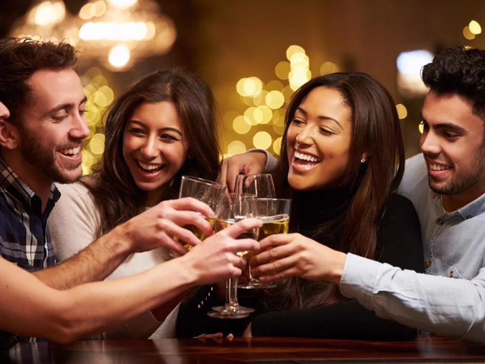 Friends raising glasses and celebrating Thanksgiving happy hour