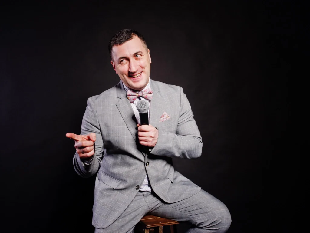Trivia host speaking into a microphone during an American cinema event