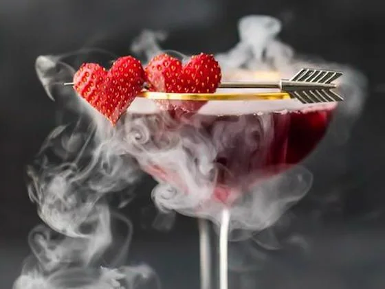 Valentine’s cocktail with strawberries and decorative arrow garnish